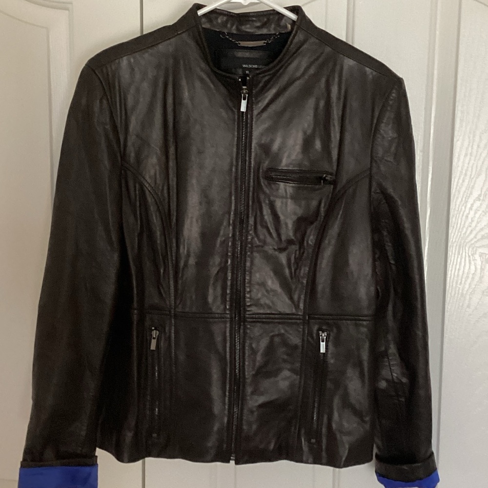 New without tags. Wilsons Leather soft Black Jacket with blue sleeve lining.